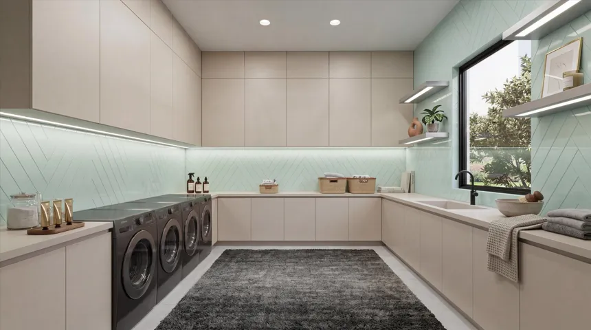 Laundry room with dual washer and dryers, along with plentiful counter and cabinet space.