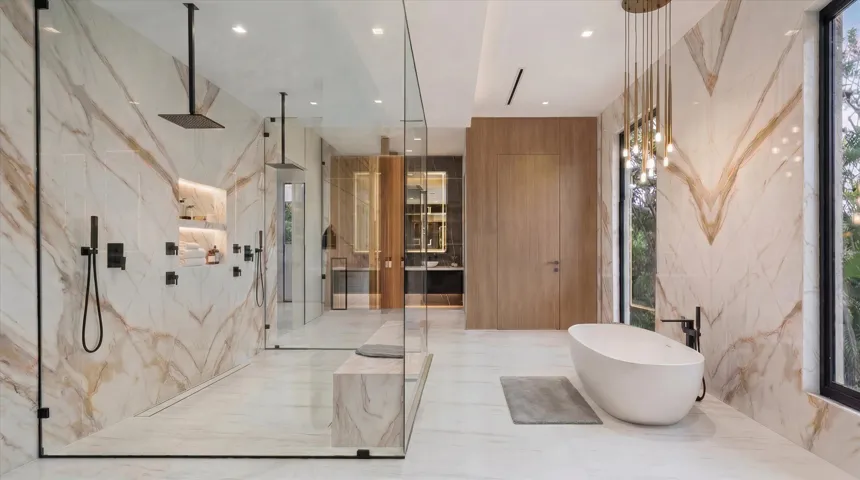 Primary bath features 464 sqft. of pure relaxation. Soaking jet tub, steam shower, double water closets, twin vanities, and on demand frosted windows. The connected wing features a cold plunge tub and sauna.