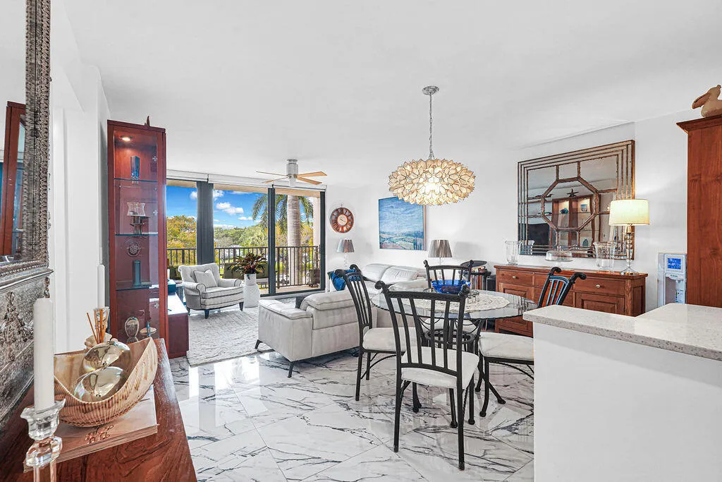 Open dining area and living area. Beautiful 24" Calcutta Spanish white porcelain tile with accent veining throughout