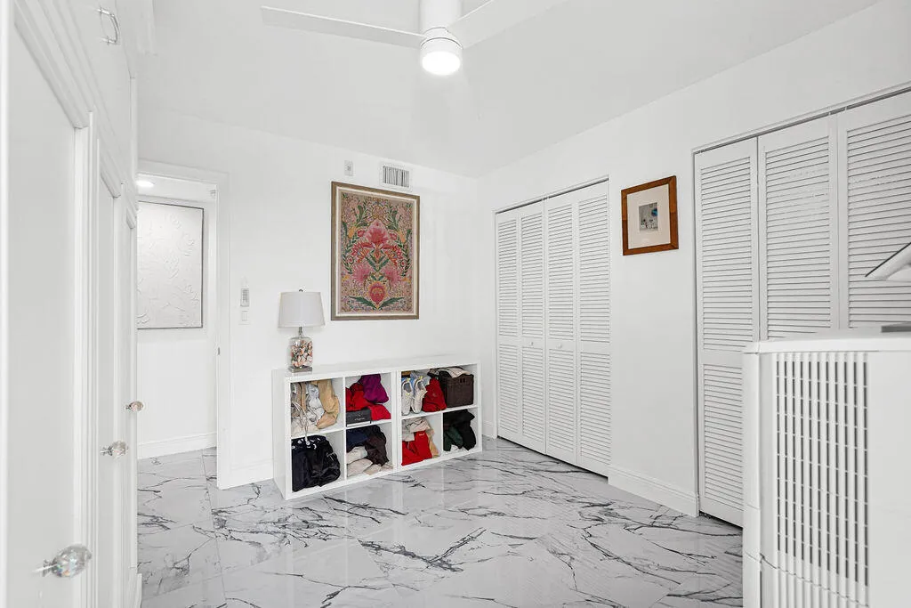 2nd bedroom with sliding glass door to balcony. Beautiful 24" Calcutta Spanish porcelain tile throughout