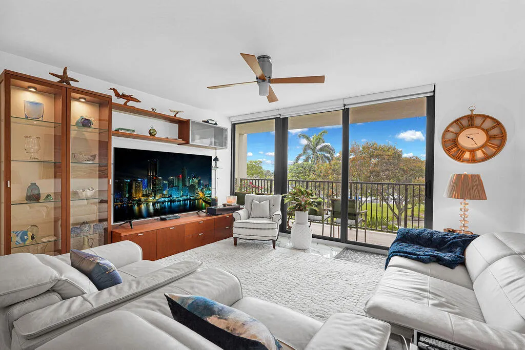 Large living room with new impact sliding glass doors to balcony