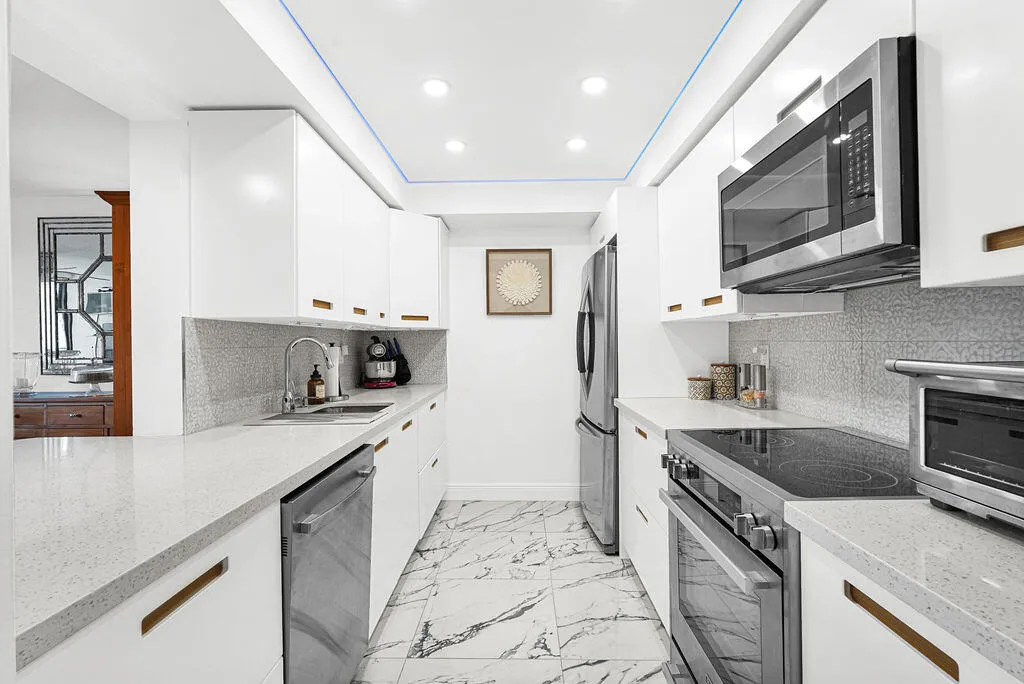 Remodeled white kitchen cabinets & quartz countertops
