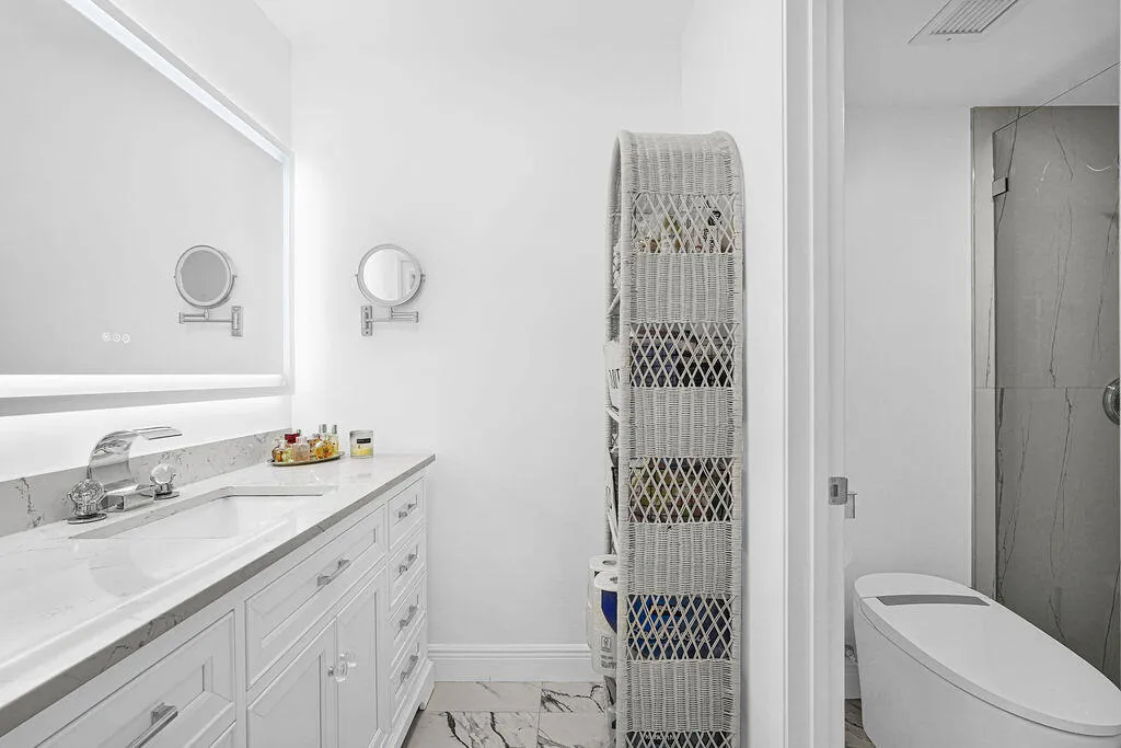 Beautiful completely remodeled primary bath with quartz countertops and lighted/heated mirror
