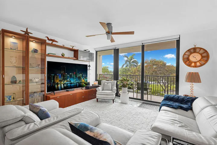 Large living room with new impact sliding glass doors to balcony