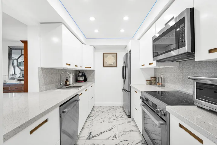 Remodeled white kitchen cabinets & quartz countertops