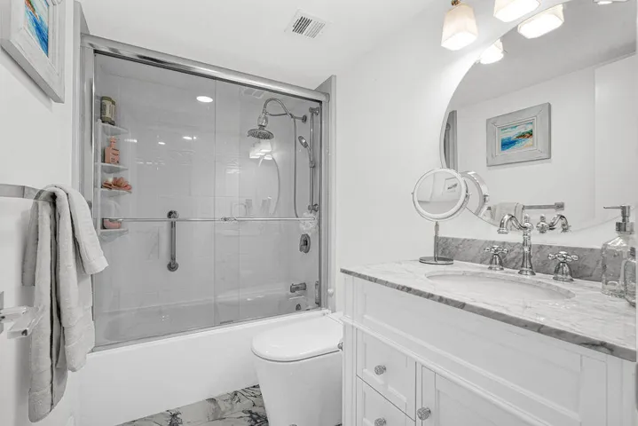 Remodeled 2nd bath with glass shower doors and quartz countertops