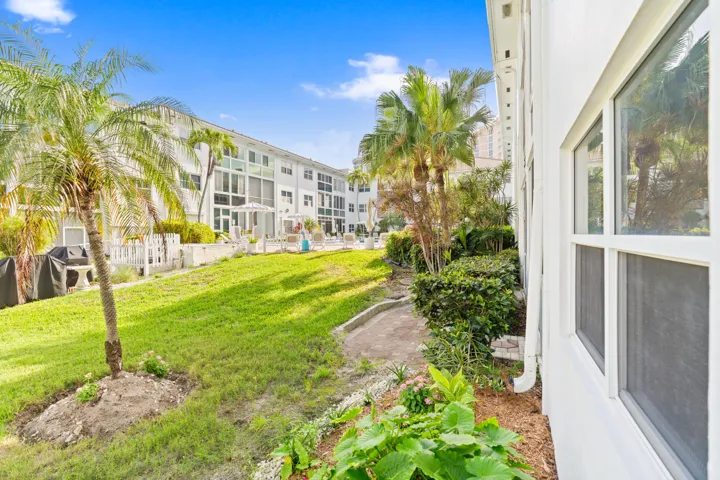 IMPACT GLASS ENCLOSED PATIO WITH DIRECT ACCESS TO COURTYARD POOL, BBQ AREA, SHUFFLEBOARD, AND CANAL BREEZEWAY.