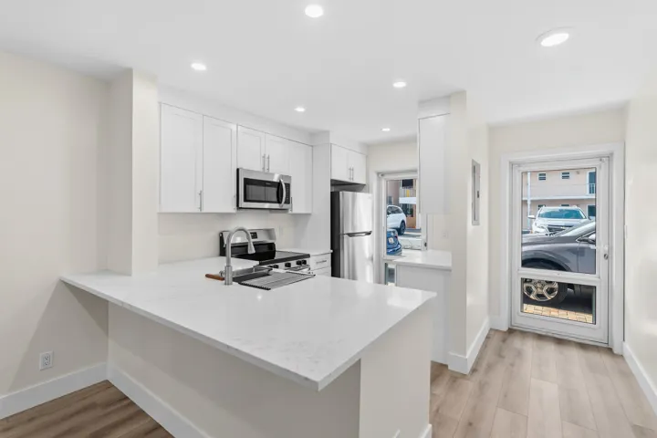 A brand NEW custom kitchen with quartz countertops, Eat in Bar, soft-close cabinets, stainless-steel appliances and ALL NEW ELECTRIC, PLUMBING, AC, AND HWH!