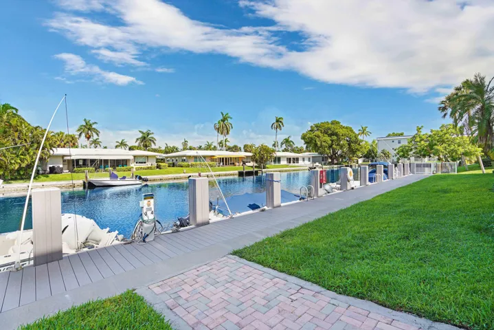 BEACH AND BOAT LOVERS DREAM LOCATION!.., FEATURING PRIVATE DEEDED BEACH ACCESS, COMMUNITY BOAT DOCK, NO FIXED BRIDGES, 1 CANAL FROM THE INTRACOASTAL WITH 6 BOAT SLIPS! Located in desirable North Leisure Gardens COMPLETELY REMODELED 2-bed, 2-bath, 1st floor, corner unit features EVERYTHING BRAND NEW!, a custom kitchen with quartz countertops, soft-close cabinets, stainless-steel appliances and ALL NEW, ELECTRIC, PLUMBING, HWH AND AC UNIT.