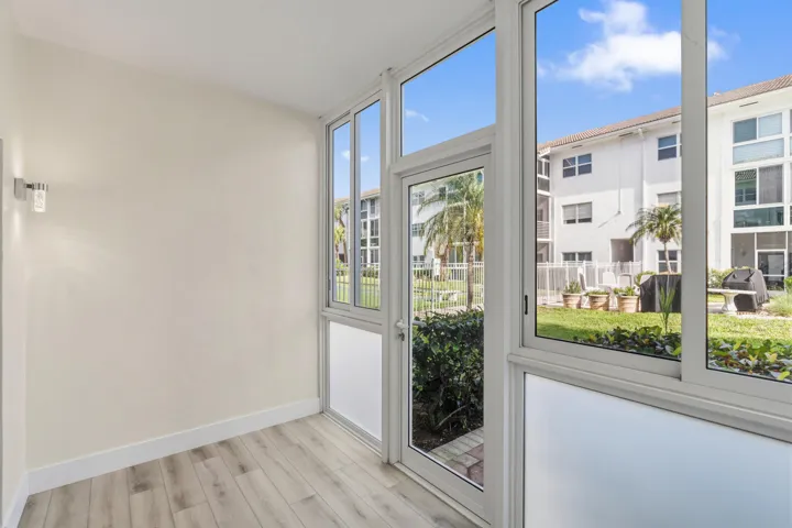 IMPACT GLASS ENCLOSED PATIO WITH DIRECT ACCESS TO COURTYARD POOL, BBQ AREA, SHUFFLEBOARD, AND CANAL BREEZEWAY.