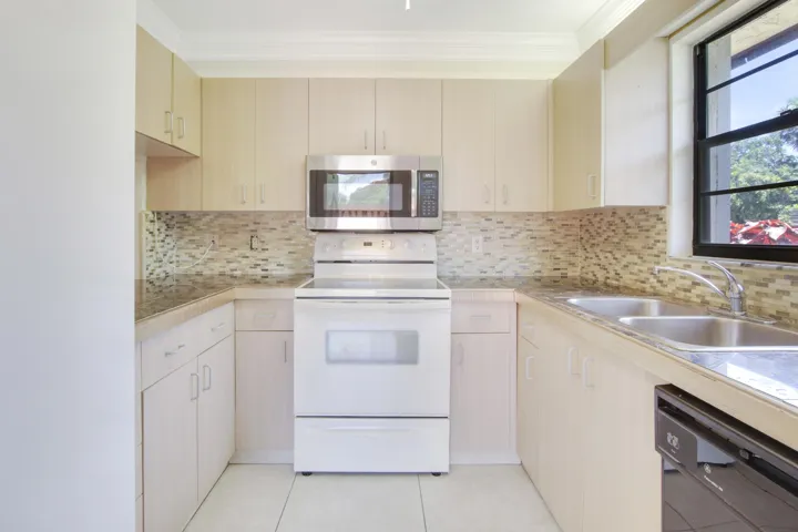 The kitchen offers an electric stove and microwave.