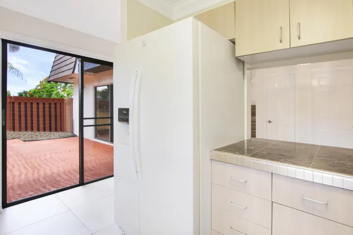 The kitchen offers a sliding glass door out to the patio.