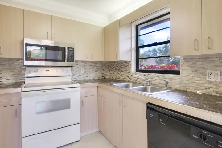 The kitchen offers a window for natural light and a dishwasher.