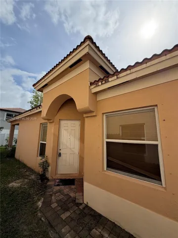 Entry to the home is located on the side of the property. Or it can also be through the garage