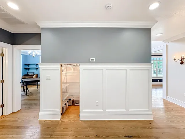 Hidden storage space in paneling of living room