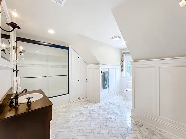 Gorgeous bathroom upstairs with herringbone marble floor