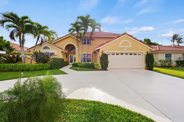 Beautifully expansive home featuring impressive curb appeal with lush tropical landscaping, mature palm trees, and a spacious curved driveway. Features include a private heated pool, a fully fenced backyard, no rear neighbors, 2 car garage, & updated kitchen with luxury appliances