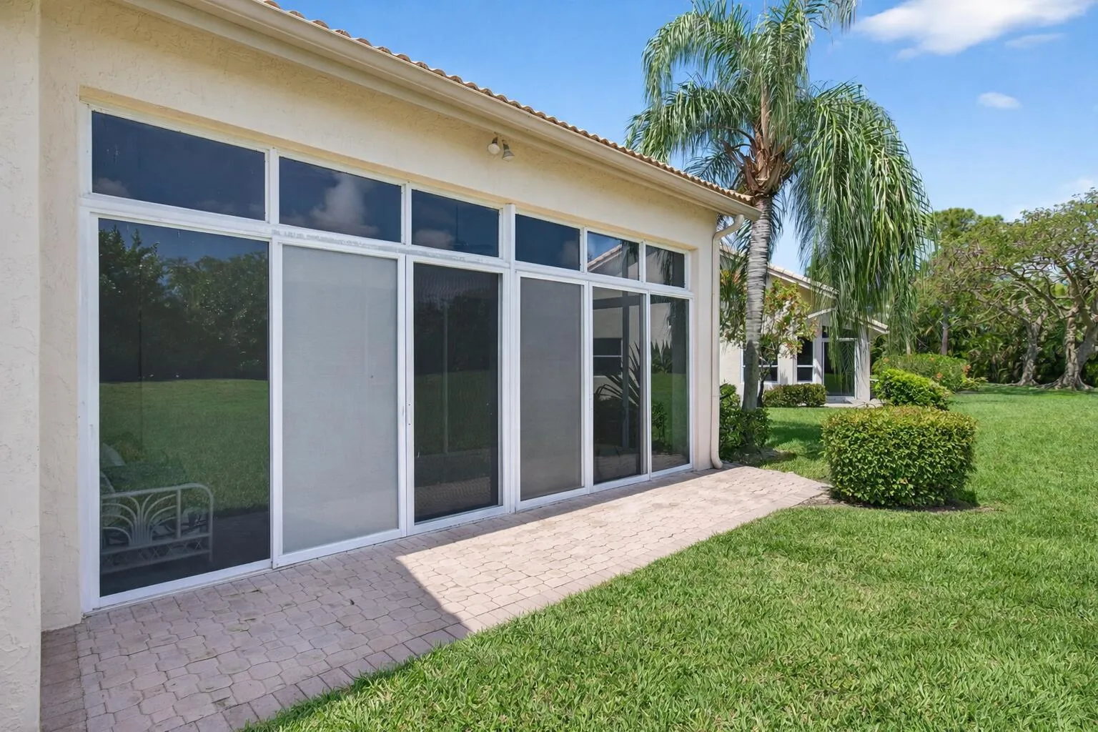 Bright patio with palm tree shadow