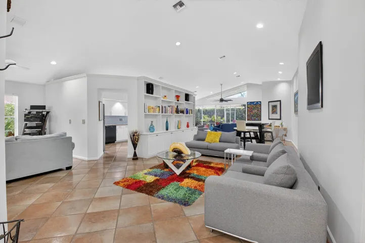 LIVING SEATING FLOW THROUGH TO DINING AND LANAI AND KITCHEN ETNRY