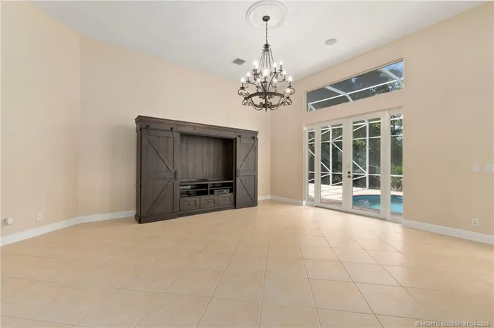 Family room with French doors to screened pool area