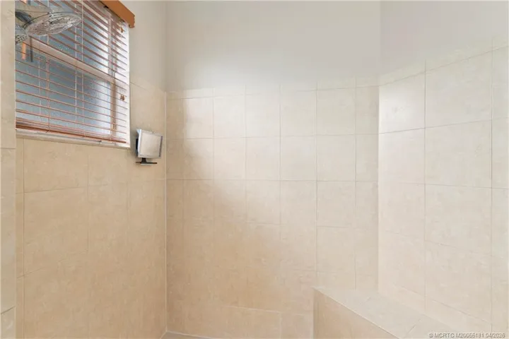 Shower with bench and glass door