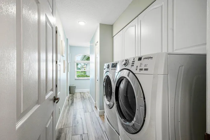 Ample storage in laundry room off garage