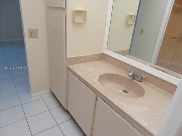 with vanity area and storage cabinet for linens