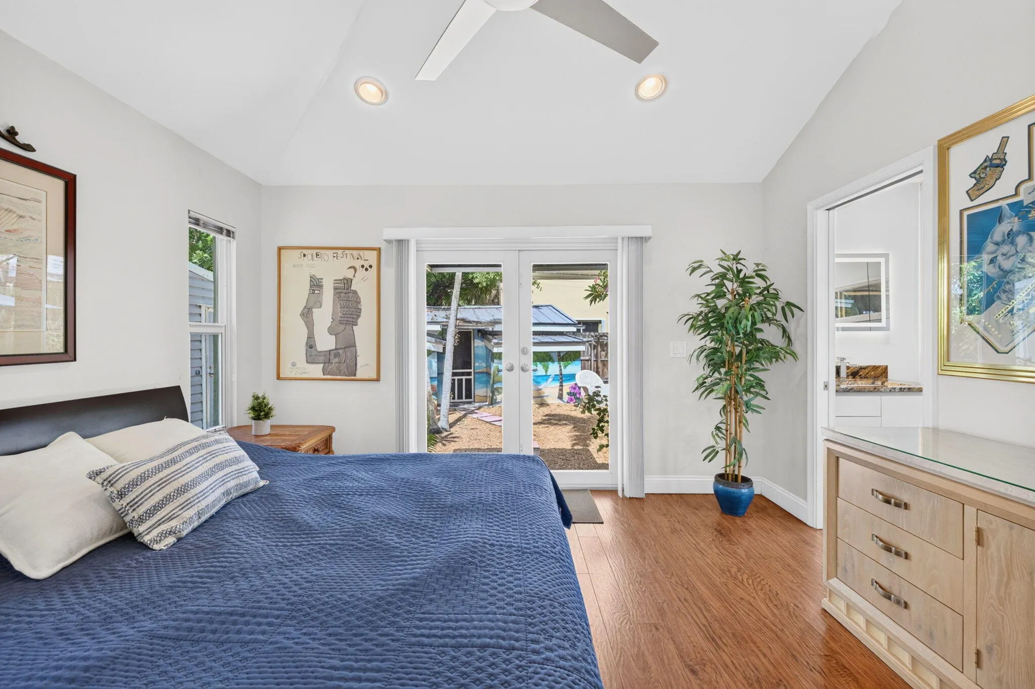 Primary bedroom, vaulted ceiling, en-suite bathroom, large closet, french door to backyard
