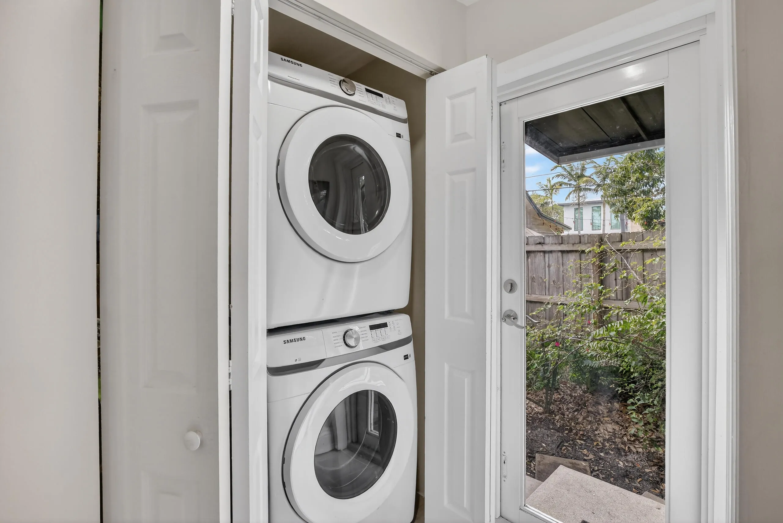New washer & dryer, in hallway between kitchen and door to backyard and to primary bed room