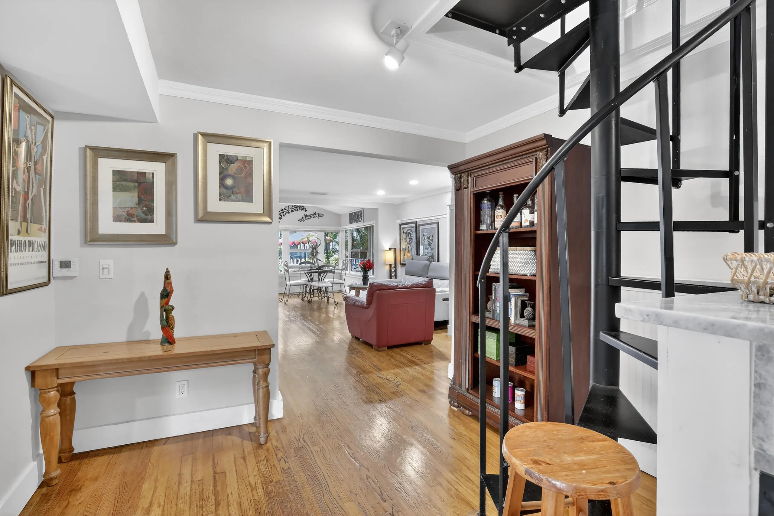 Kitchen sitting area with spiral staircase to attic loft.