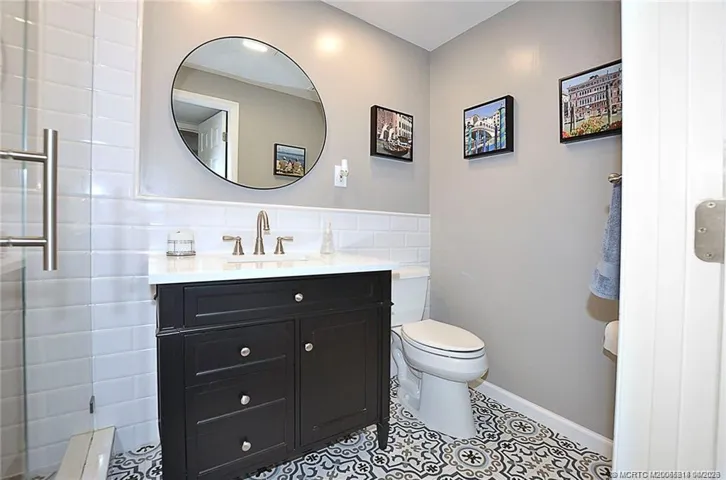 Step into this beautifully renovated bathroom with a sleek glass-enclosed shower, timeless subway tile, and designer finishes that create a fresh, spa-like feel