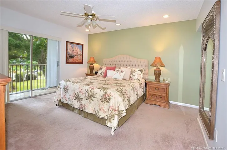 Wake up to serene green views from your spacious primary suite, complete with direct access to the lanai—perfect for enjoying your morning coffee in the fresh Florida air.
