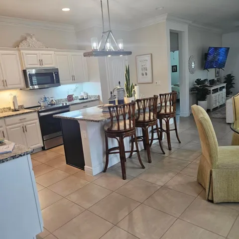 Kitchen with custom quartz bar ..Great entertainment feature.