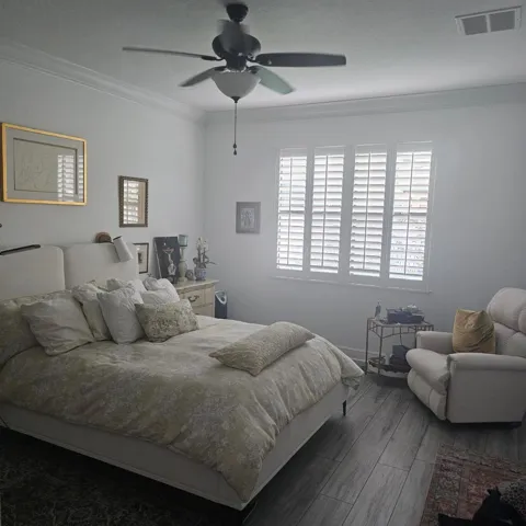 Master Bedroom plank floors, plantation shutters ceiling fan, Oversized cove molding and oversized base molding fresh paint wit en suite bathroom & walk in closet