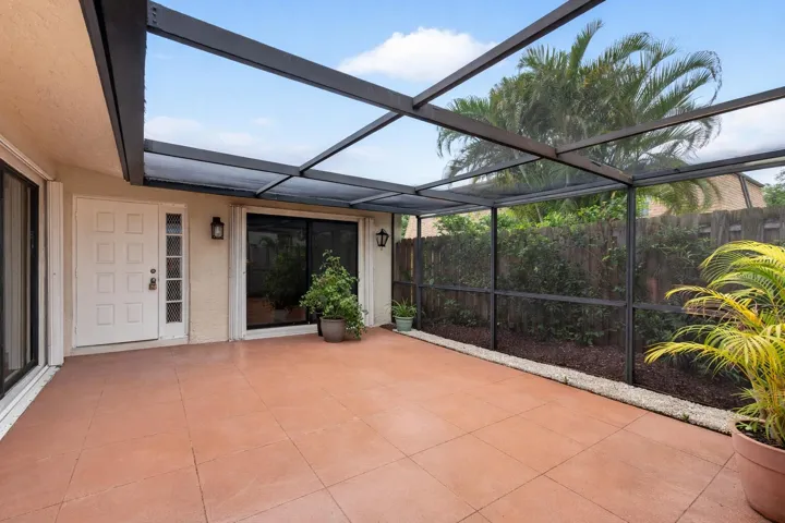 Sunny screened patio with plants