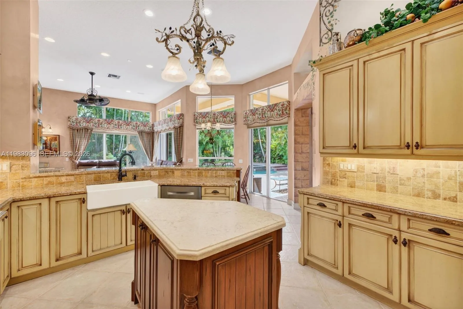 Beautiful handpainted murals and finishes resemble an al fresco restaurant in Europe. Volume Ceilings, Gorgeous painted walls and upgraded wood cabinets, farmhouse sink, high end iron and alabaster fixture in kitchen and another high end fixture over eat in kitchen table. Counter seating and center island in kitchen. Dacor refrigerator, tumbled marble backsplash Beautiful handpainted murals and finishes resemble an al fresco restaurant in Europe. Volume Ceilings, Gorgeous painted walls and upgraded wood cabinets, farmhouse sink, high end iron and alabaster fixture in kitchen and another high end fixture over eat in kitchen table. Counter seating and center island in kitchen. Dacor refrigerator, tumbled marble backsplash