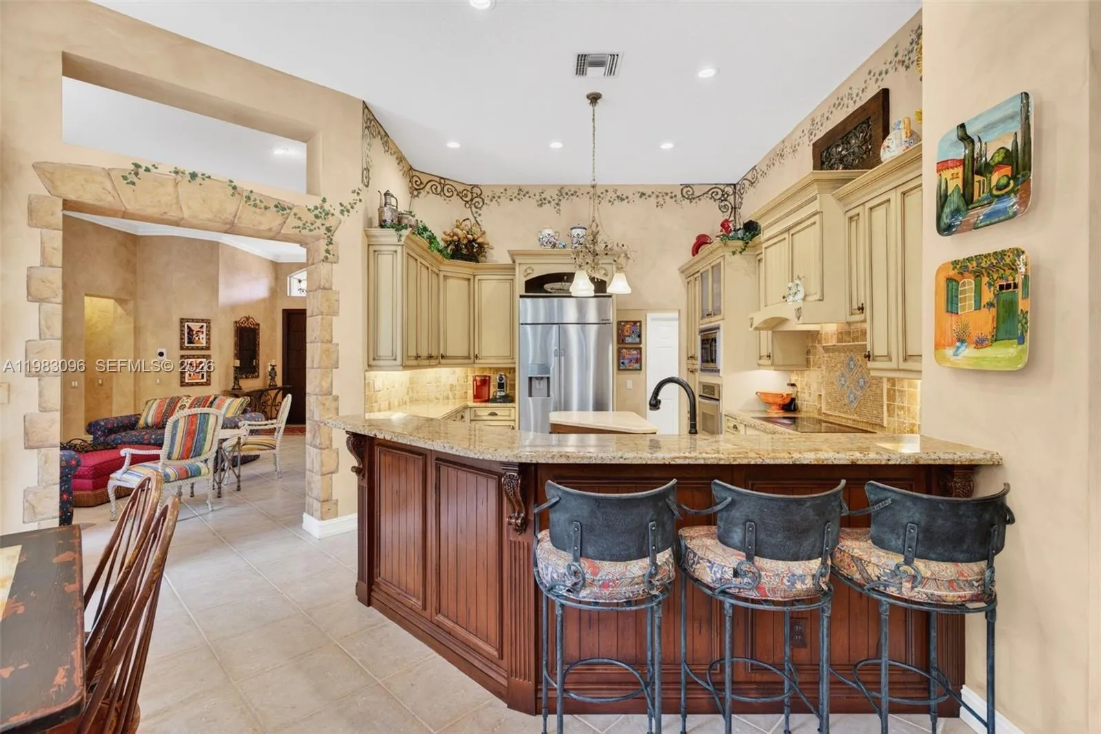 Beautiful handpainted murals and finishes resemble an al fresco restaurant in Europe. Volume Ceilings, Gorgeous painted walls and upgraded wood cabinets, farmhouse sink, high end iron and alabaster fixture in kitchen and another high end fixture over eat in kitchen table. Counter seating and center island in kitchen. Dacor refrigerator, tumbled marble backsplash Beautiful handpainted murals and finishes resemble an al fresco restaurant in Europe. Volume Ceilings, Gorgeous painted walls and upgraded wood cabinets, farmhouse sink, high end iron and alabaster fixture in kitchen and another high end fixture over eat in kitchen table. Counter seating and center island in kitchen. Dacor refrigerator, tumbled marble backsplash