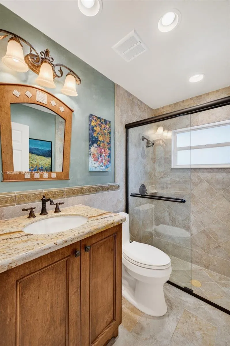 Guest Bathroom is upgraded w/ glass shower door, upgraded vanity and granite counter Guest Bathroom is upgraded w/ glass shower door, upgraded vanity and granite counter