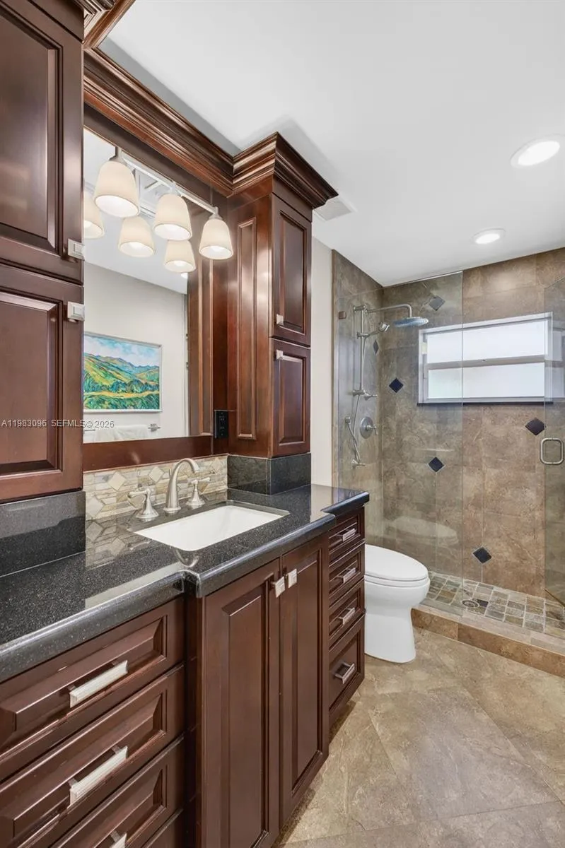Upgraded guest bathroom w/ wood cabinets and granite counter Upgraded guest bathroom w/ wood cabinets and granite counter