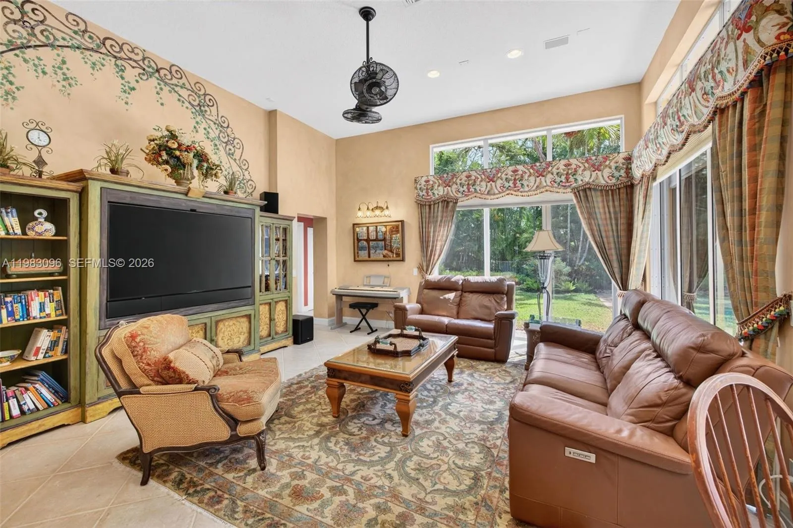 Great room w/ custom wall paintings and window treatments, and ceiling fan Great room w/ custom wall paintings and window treatments, and ceiling fan