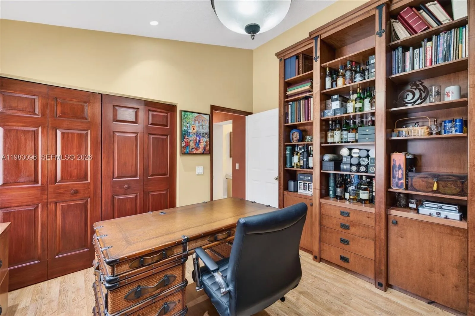 Bedroom converted to an office w/ custom millwork, built in wood cabinets with storage, filing cabinets and beverage cooler Bedroom converted to an office w/ custom millwork, built in wood cabinets with storage, filing cabinets and beverage cooler