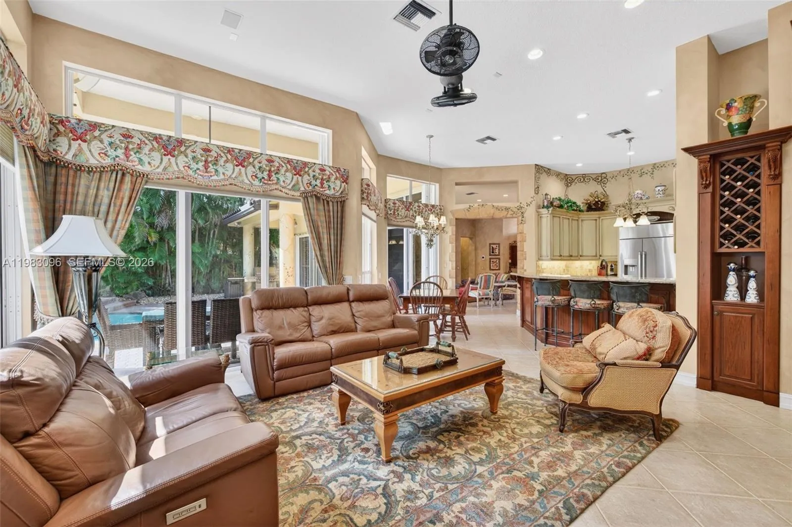 Family Room / Great room w/ volume ceilings and custom painted walls, window shades and valances and beautiful fan Family Room / Great room w/ volume ceilings and custom painted walls, window shades and valances and beautiful fan