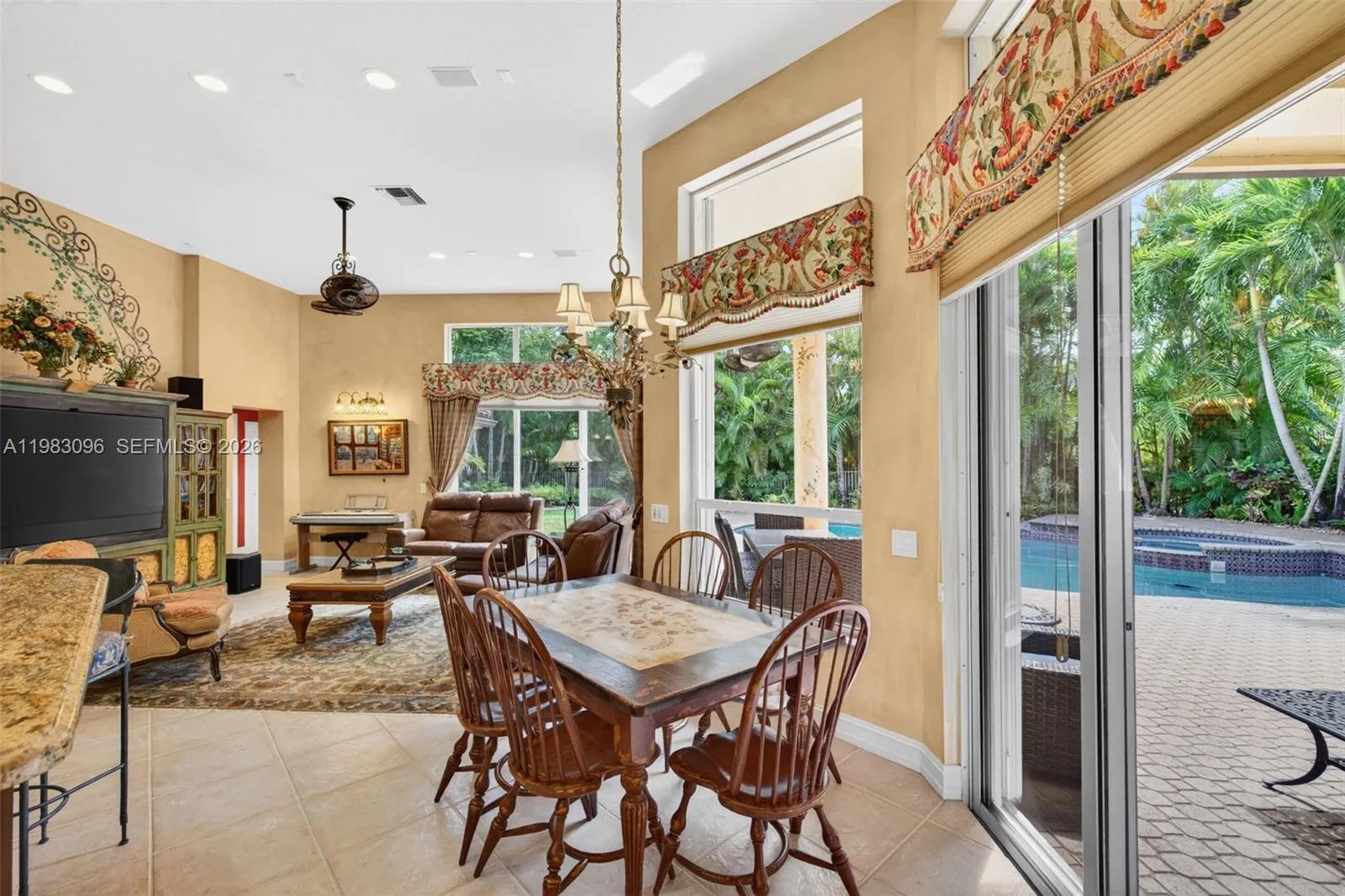 Beautiful handpainted murals and finishes resemble an al fresco restaurant in Europe. Volume Ceilings, Gorgeous painted walls, high end fixture over eat in kitchen table. Custom window treatments / valances and great natural light looks over pool area and tropical backyard Beautiful handpainted murals and finishes resemble an al fresco restaurant in Europe. Volume Ceilings, Gorgeous painted walls, high end fixture over eat in kitchen table. Custom window treatments / valances and great natural light looks over pool area and tropical backyard
