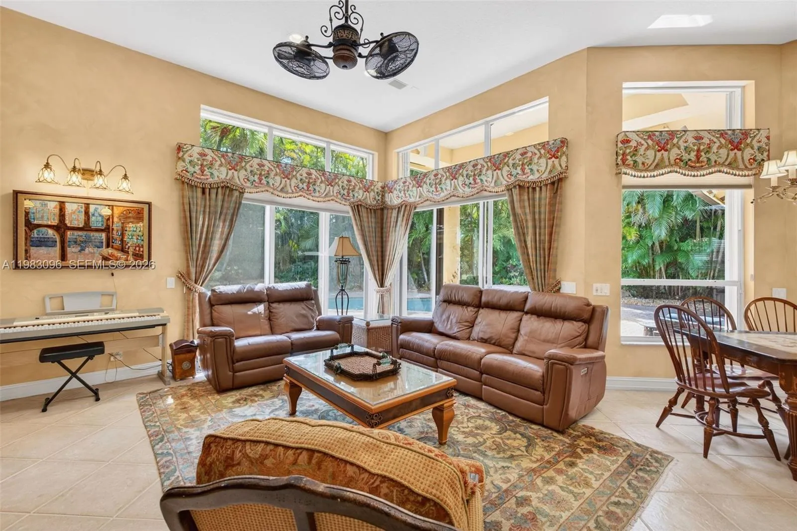 Family Room / Great room w/ volume ceilings and custom painted walls, window shades and valances and beautiful fan Family Room / Great room w/ volume ceilings and custom painted walls, window shades and valances and beautiful fan