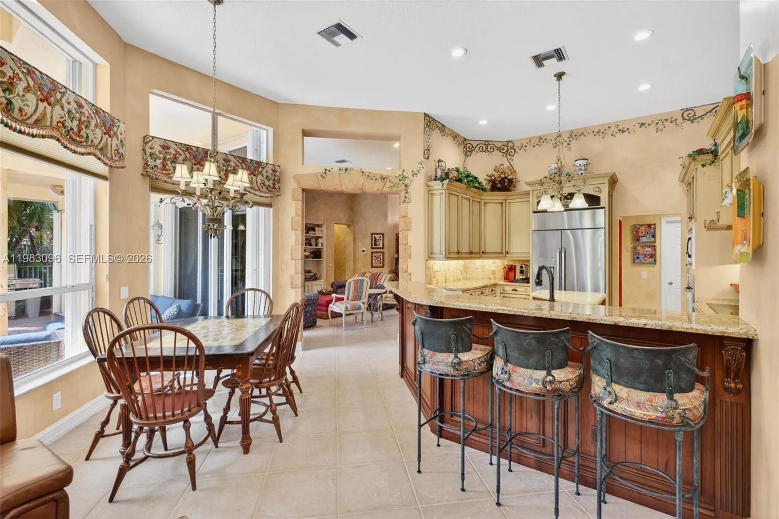 Beautiful handpainted murals and finishes resemble an al fresco restaurant in Europe. Volume Ceilings, Gorgeous painted walls and upgraded wood cabinets, farmhouse sink, high end iron and alabaster fixture in kitchen and another high end fixture over eat in kitchen table. Counter seating and center island in kitchen. Dacor refrigerator, tumbled marble backsplash Beautiful handpainted murals and finishes resemble an al fresco restaurant in Europe. Volume Ceilings, Gorgeous painted walls and upgraded wood cabinets, farmhouse sink, high end iron and alabaster fixture in kitchen and another high end fixture over eat in kitchen table. Counter seating and center island in kitchen. Dacor refrigerator, tumbled marble backsplash