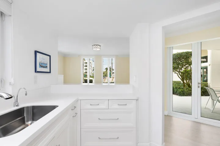 Kitchen overlooking dining room and patio