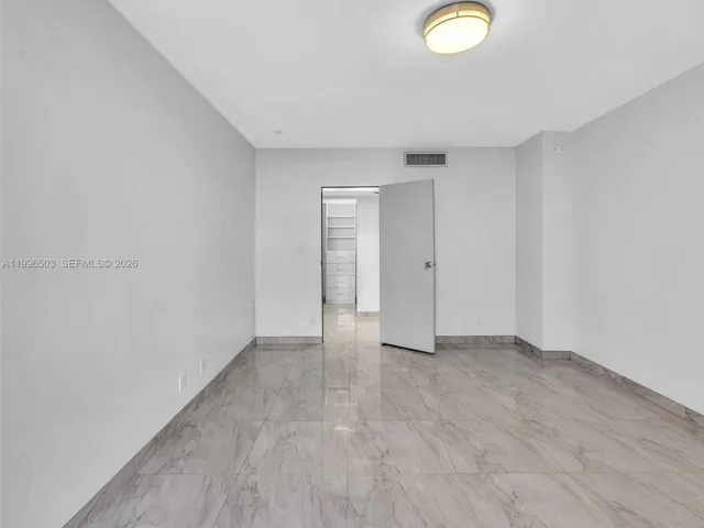 Bedroom with walk-in closet located across