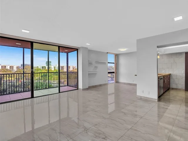 Spacious living area with extended open layout and balcony view
