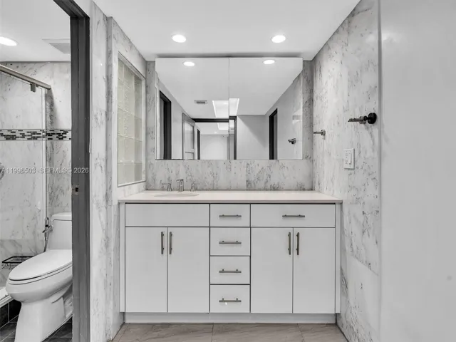 Spacious vanity area with separate shower and toilet room