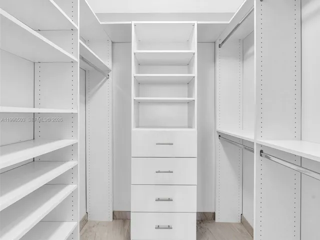 Custom walk-in closet with built-in shelving and drawers
